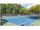 A full shot of a vibrant, well-maintained tennis court, perfect for sports enthusiasts at 3045 Wyntree Dr, Peachtree Corners, GA 30071