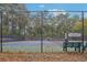 View of the community tennis court showing the green surface and surrounding trees at 3045 Wyntree Dr, Peachtree Corners, GA 30071