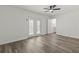 Bright bedroom with wood-look flooring, ceiling fan, and access to outdoor area at 4269 Indian Forest Trl, Stone Mountain, GA 30083