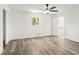 Spacious bedroom with wood-look floors, a ceiling fan, and access to ensuite bathroom at 4269 Indian Forest Trl, Stone Mountain, GA 30083