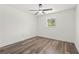 Cozy bedroom with wood-look flooring, ceiling fan, and a large window at 4269 Indian Forest Trl, Stone Mountain, GA 30083