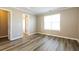 Bright bedroom featuring hardwood floors, a window, and neutral wall paint at 1501 Buckingham Pl, Stockbridge, GA 30281