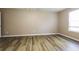 Bright bedroom with wood-look floors and a window offering natural light; simple and inviting space at 1501 Buckingham Pl, Stockbridge, GA 30281