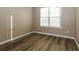 Comfortable bedroom features a window, wood-look floors, and neutral paint, creating a relaxing atmosphere at 1501 Buckingham Pl, Stockbridge, GA 30281