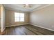 Spacious bedroom with hardwood floors, a ceiling fan, and ample natural light at 1501 Buckingham Pl, Stockbridge, GA 30281