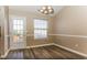Cozy dining room area with a chandelier, hardwood floors, and a window at 1501 Buckingham Pl, Stockbridge, GA 30281