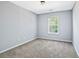 Bedroom with neutral walls, plush carpet, and a window providing natural light at 2872 Cross Creek Ct, Cumming, GA 30040