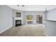 Bright living room with a fireplace and multiple sliding doors with a view, carpet floors, and a chandelier at 2872 Cross Creek Ct, Cumming, GA 30040