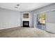 Living room with fireplace, carpet floors, and sliding glass doors leading to an outdoor area at 2872 Cross Creek Ct, Cumming, GA 30040