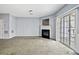 Bright living room with fireplace, carpet floors, and sliding glass doors with a view at 2872 Cross Creek Ct, Cumming, GA 30040