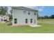 View of the house's backyard with well-maintained lawn and patio at 40 Begonia Ct, Covington, GA 30016