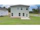 View of the house's backyard with well-maintained lawn and patio at 40 Begonia Ct, Covington, GA 30016