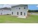 View of the house's backyard with well-maintained lawn and patio at 40 Begonia Ct, Covington, GA 30016