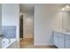 Bright bathroom featuring double vanity with modern fixtures, tile flooring, shower and a tub at 40 Begonia Ct, Covington, GA 30016