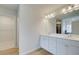 Bright bathroom featuring double vanity with modern fixtures, tile flooring, and an entrance to the closet at 40 Begonia Ct, Covington, GA 30016