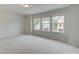 Bedroom with carpet floors, natural lighting from three large windows, and neutral color palette at 40 Begonia Ct, Covington, GA 30016