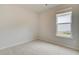 Neutral bedroom featuring carpet flooring, a window with blinds, and white walls at 40 Begonia Ct, Covington, GA 30016