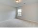 Bedroom with neutral paint, carpeted flooring, and a bright window offering natural light at 40 Begonia Ct, Covington, GA 30016
