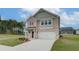 Charming two-story home with brick facade, a well-manicured lawn, and an attached two-car garage at 40 Begonia Ct, Covington, GA 30016