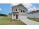 Charming two-story home with brick facade, a well-manicured lawn, and an attached two-car garage at 40 Begonia Ct, Covington, GA 30016