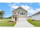 Charming two-story home with brick facade, a well-manicured lawn, and an attached two-car garage at 40 Begonia Ct, Covington, GA 30016