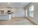 Well-lit kitchen boasts an island, stainless steel appliances, and white cabinets with light wood flooring at 40 Begonia Ct, Covington, GA 30016