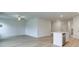 Spacious open-concept living area connected to kitchen with center island and light wood flooring at 40 Begonia Ct, Covington, GA 30016