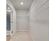 Large walk-in closet featuring built-in shelving for optimal organization, and a doorway to an ensuite bath at 40 Begonia Ct, Covington, GA 30016