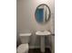 Cozy half bath with pedestal sink, stylish mirror, and tile flooring at 558 Fairview Oak Place, Dallas, GA 30157