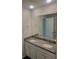 Bathroom with double vanity, granite countertops, white cabinets and large mirror at 558 Fairview Oak Place, Dallas, GA 30157