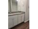 Bathroom with double vanity, granite countertops, white cabinets and luxury vinyl flooring at 558 Fairview Oak Place, Dallas, GA 30157
