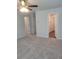Bedroom featuring neutral walls, carpet, ceiling fan, and entryways with doors at 558 Fairview Oak Place, Dallas, GA 30157