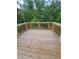 Exterior wood deck surrounded by a wooden railing and lush green trees at 558 Fairview Oak Place, Dallas, GA 30157