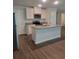 Modern kitchen featuring white cabinets, granite countertops, stainless steel appliances, and an island at 558 Fairview Oak Place, Dallas, GA 30157