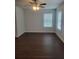 Bright living room with ceiling fan, wood floors, and large windows providing ample natural light at 558 Fairview Oak Place, Dallas, GA 30157