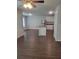 Open-concept living space with dark wood-look flooring, stainless steel appliances, and granite countertops at 558 Fairview Oak Place, Dallas, GA 30157