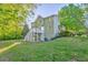 Expansive backyard with lush greenery, mature trees, and multi-level deck at 6 Sentry Rdg, Dallas, GA 30157