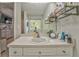 Bright bathroom featuring a white vanity, large mirror, and open shelving for stylish storage at 6 Sentry Rdg, Dallas, GA 30157