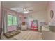 Charming bedroom with pink walls, ceiling fan, and a cozy reading nook by the window at 6 Sentry Rdg, Dallas, GA 30157