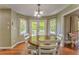 Sunlit breakfast nook with hardwood floors, round table, and backyard access at 6 Sentry Rdg, Dallas, GA 30157