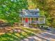 Beautiful two-story home featuring a charming front porch surrounded by lush trees at 6 Sentry Rdg, Dallas, GA 30157