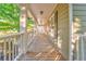 Inviting covered front porch with wood flooring and elegant white columns at 6 Sentry Rdg, Dallas, GA 30157