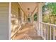 Picturesque covered front porch with wood flooring and decorative white railings at 6 Sentry Rdg, Dallas, GA 30157