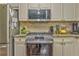 Close-up of kitchen featuring stainless steel oven, gas range, and granite counters at 6 Sentry Rdg, Dallas, GA 30157