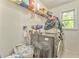 Functional laundry room with modern washer, dryer, and overhead shelving for storage at 6 Sentry Rdg, Dallas, GA 30157