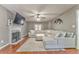 Cozy living room showcases a fireplace, large sectional sofa, and modern television for comfortable living at 6 Sentry Rdg, Dallas, GA 30157