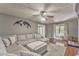 Comfortable living room features a large sectional sofa, ceiling fan, and stylish decor for a relaxing atmosphere at 6 Sentry Rdg, Dallas, GA 30157