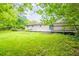 Large grassy backyard with a patio, deck and abundant shade trees creating a peaceful outdoor retreat at 110 Valley View Ct, Tyrone, GA 30290