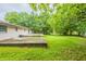 Spacious backyard with green grass, mature trees, and a concrete patio at 110 Valley View Ct, Tyrone, GA 30290