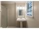 Bathroom featuring a vanity sink with white pedestal and a shower with glass door at 110 Valley View Ct, Tyrone, GA 30290